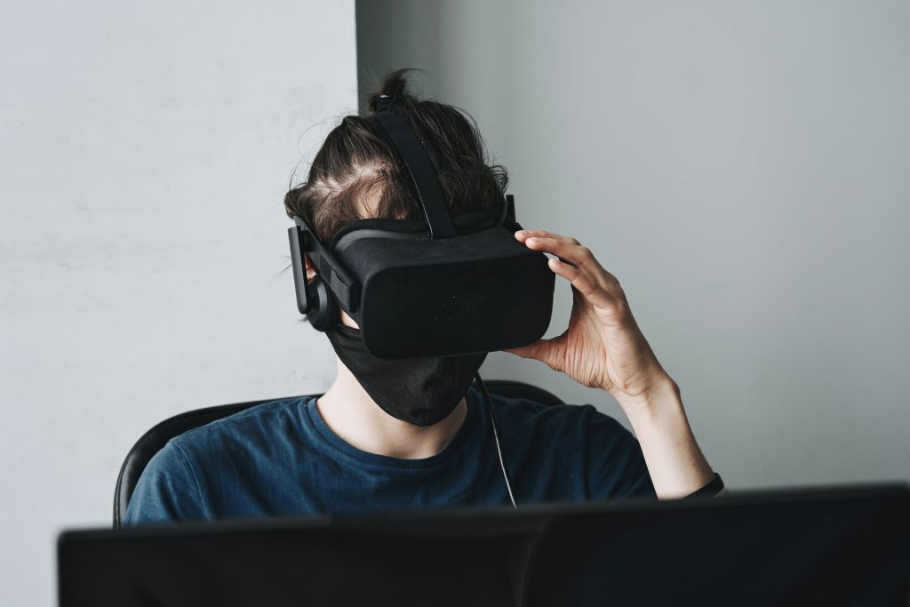 AI in blockchain gaming - a person wearing a VR device